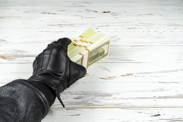 Crime Concept Man In Black Leather Gloves Holding Bricks Of Money - Photo, Image