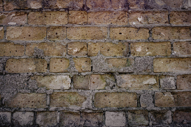old brick wall and missing bricks in ruins. - Photo, Image