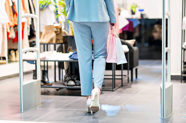 Mujer feliz comprando ropa en la tienda
 - Foto, Imagen