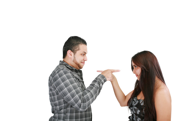 Young couple pointing at each other against a white background - Photo, Image