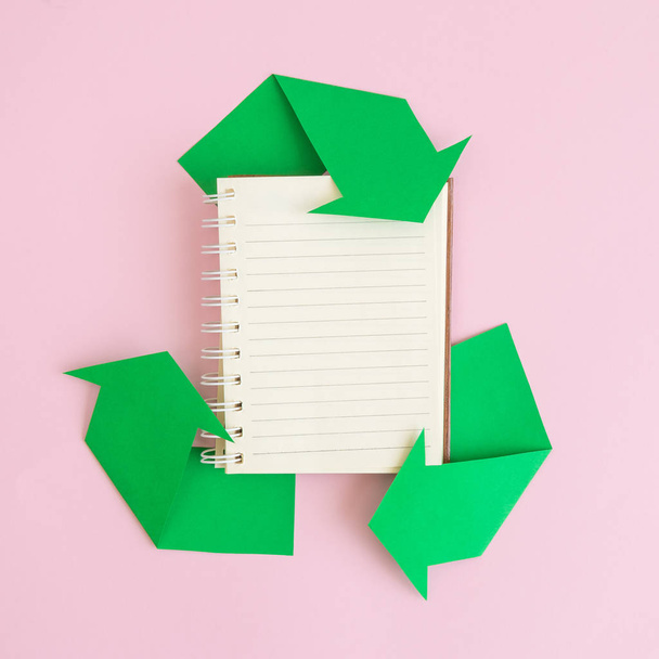 Flat lay of notebook and recycle icon made of paper abstract. Space for copy. - Foto, afbeelding