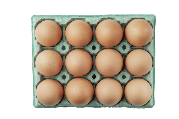 Twelve chicken eggs in paper packaging close-up. - Photo, Image