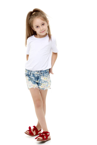 Little girl in a pure white t-shirt for advertising and shorts. - Photo, Image