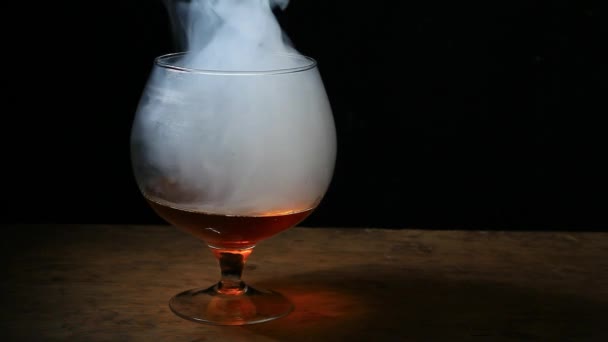 whiskey glass smoke dark background nobody hd footage  - Video