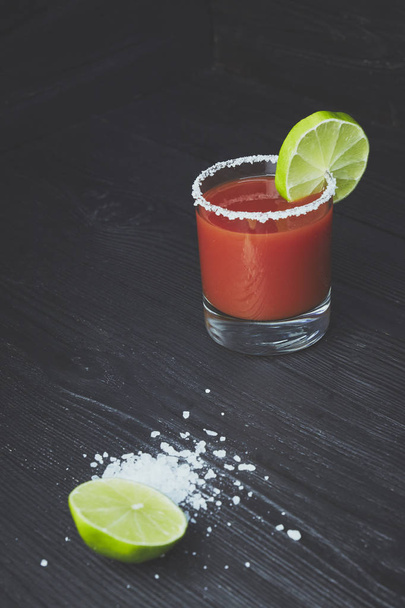 cocktail Bloody Mary or Caesar with lemon and lime on a black wood background - Foto, immagini