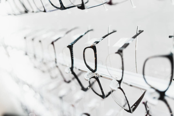 Eyeglasses frames in optical store. - Foto, afbeelding