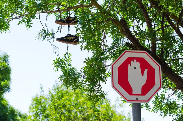Camino equivocado Detener signo y zapatos en el árbol
 - Foto, imagen
