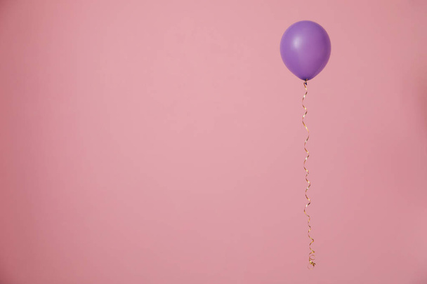 Bright balloon on color background, space for text. Celebration time - Fotó, kép