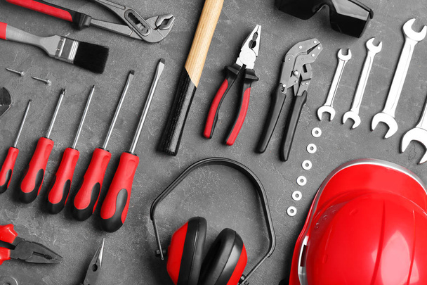 Flat lay composition with different construction tools on grey background - 写真・画像