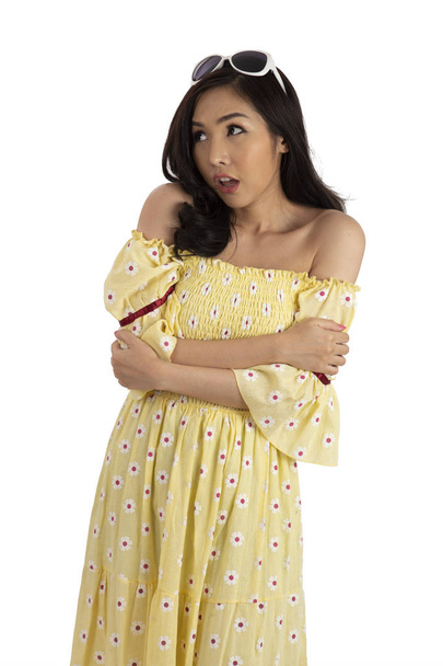 Portrait of cute girl wearing yellow dress in surprise action. - Фото, зображення