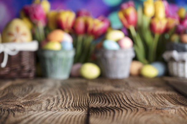 Easter background. Easter decorations. Rustic wooden table. Easter basket with eggs. Blue bokeh background. - Photo, Image