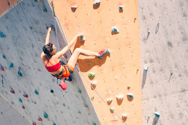 A girl climbs a climbing wall. - Photo, Image