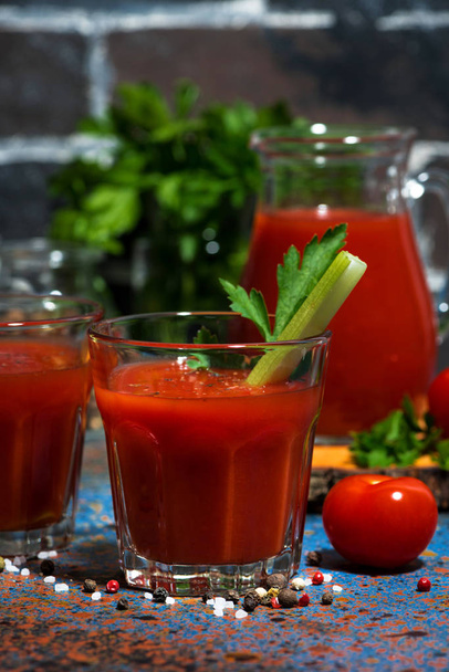 fresh tomato juice with celery in glasses, vertical - 写真・画像