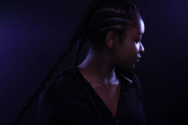Cool and Beautiful Black Female Model Looking Away In Purple Light - Valokuva, kuva