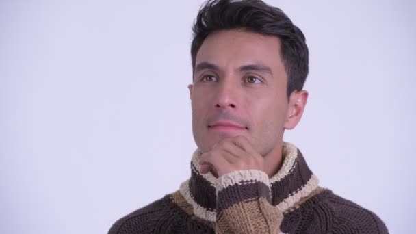 Face of young happy Hispanic man thinking ready for winter - Filmagem, Vídeo