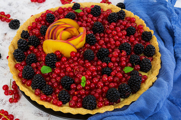 Delicious tart with red currants, peach and blackberries - Photo, Image