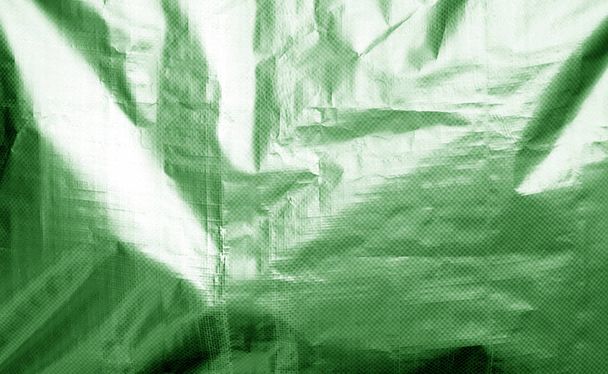 Металізована текстура пластикової обгортки з малинами зеленого кольору
. - Фото, зображення