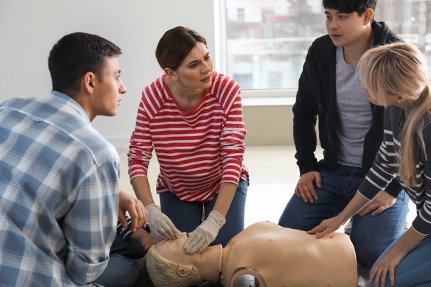 People learning to perform CPR at first aid training course - Fotoğraf, Görsel