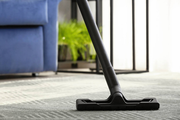 Brush of vacuum cleaner on carpet in room - Photo, Image
