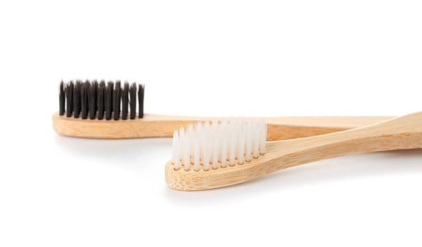 Wooden toothbrushes on white background - Foto, Imagen