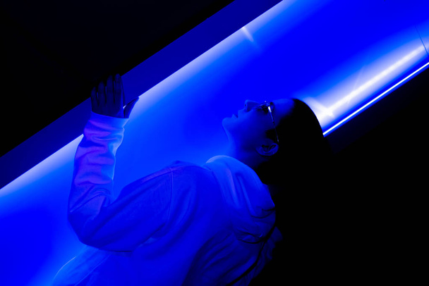 Basso ritratto chiave di una donna dai capelli corti in una luce al neon
 - Foto, immagini