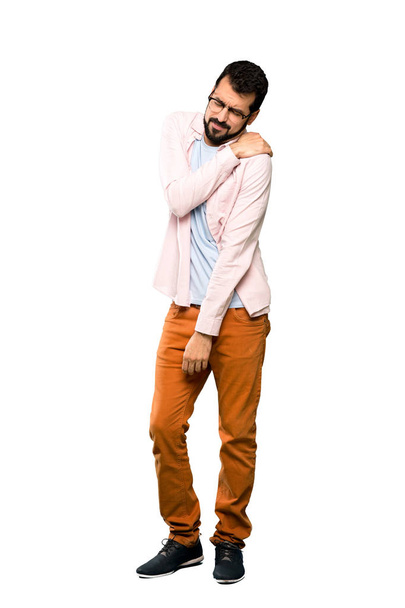 Full-length shot of Handsome man with beard suffering from pain in shoulder for having made an effort over isolated white background - Photo, Image