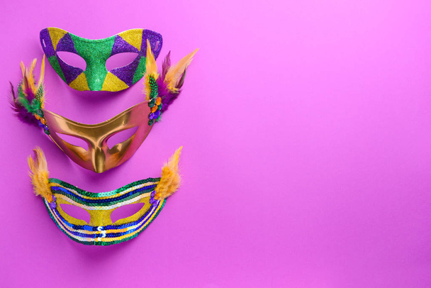 Festive masks on color background - Photo, Image