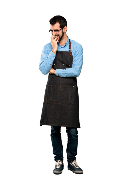 Full-length shot of Man with apron smiling a lot over isolated white background - Fotoğraf, Görsel