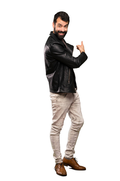 Handsome man with beard pointing back over isolated white background - Photo, Image