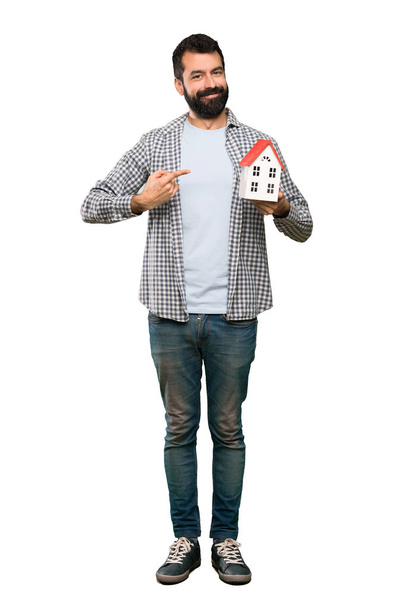 Handsome man with beard holding a little house - Foto, Imagem