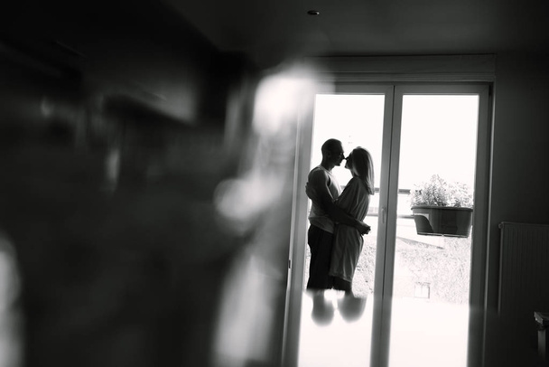 Couple with closed eyes. Woman and man near window. My love is true. - Photo, Image
