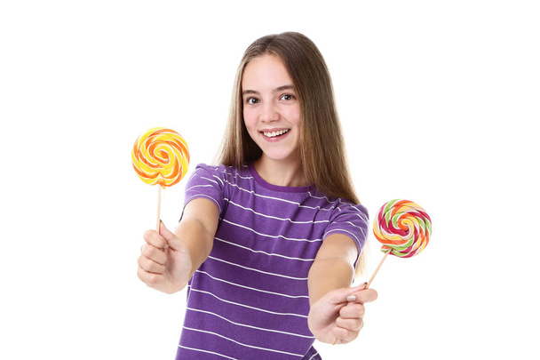 Young girl with lollipops on white background - Fotó, kép