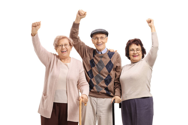 Cheerful seniors holding their hands up isolated on white background - Foto, Imagen
