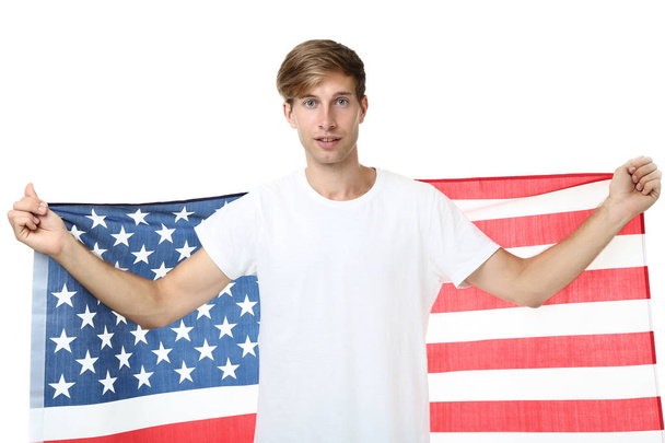 Beautiful young man holding an American flag on white background - Фото, зображення