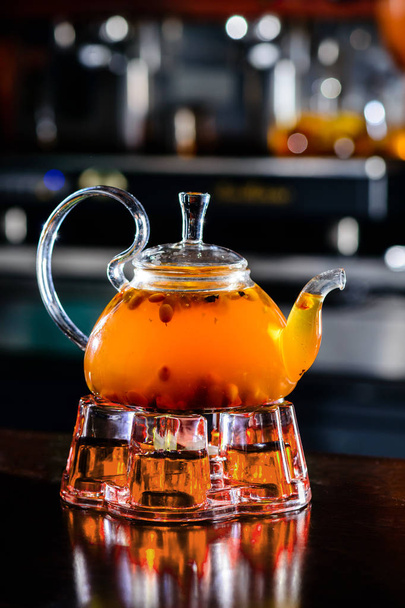 Sea buckthorn tea in glass teapot - Fotoğraf, Görsel