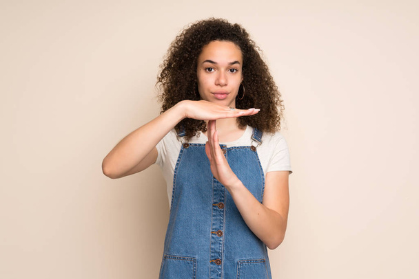 Dominican woman with overalls making time out gesture - Photo, Image