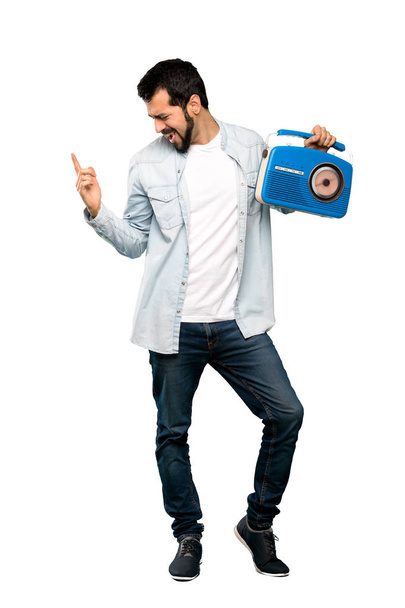 Handsome man with beard holding a radio - Fotoğraf, Görsel
