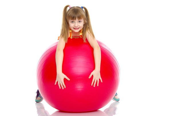 little girl doing exercises on a big ball for fitness. - Foto, afbeelding