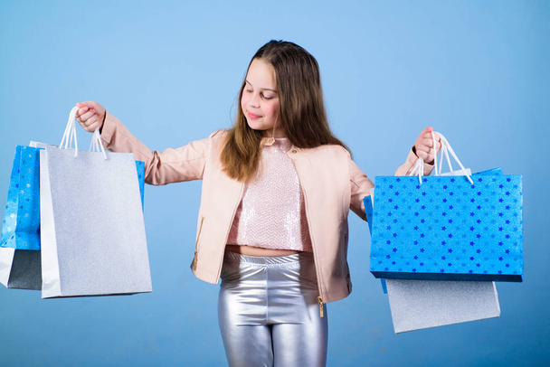 Birthday girl shopping. Fashion boutique. Fashion trend. Fashion shop. Little girl with bunch packages. Fashion girl customer. Happy child in shop with bags. Shopping day happiness. Buy clothes - Fotoğraf, Görsel