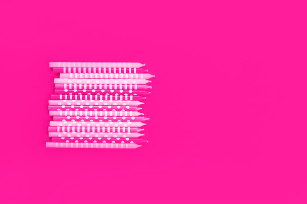 Row of neon candles on pink background - Valokuva, kuva