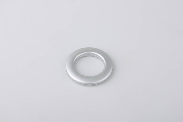 Curtain grommet ring for cornice fixing on grey background - Fotografie, Obrázek