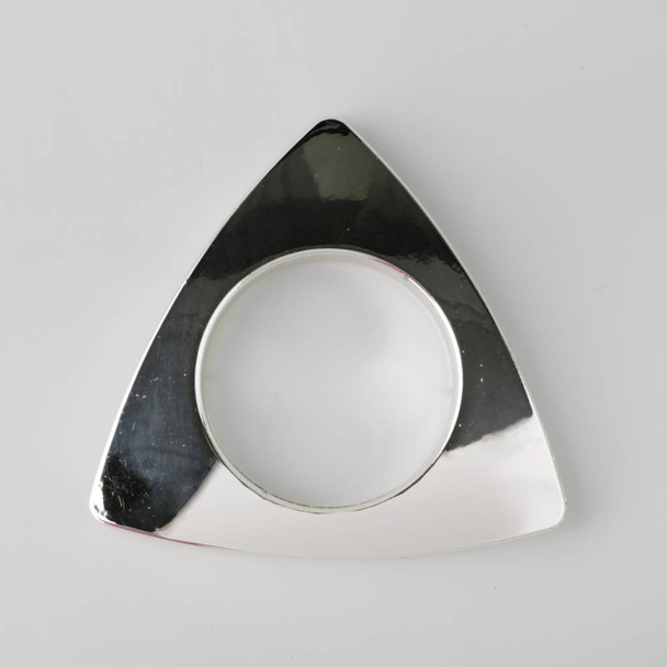 Curtain grommet triangle for cornice fixing on grey background - Foto, Imagen