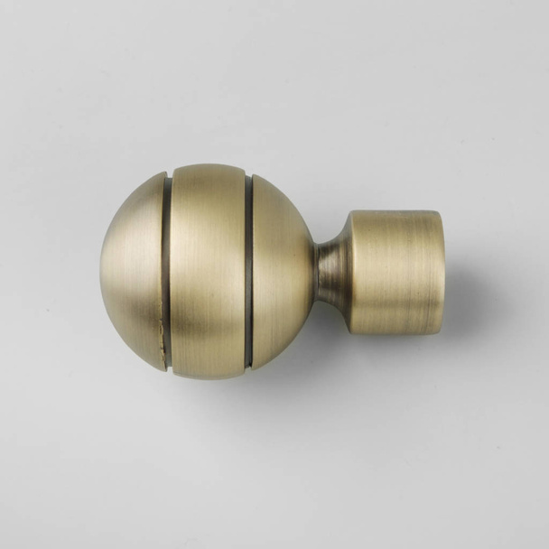 Ball-shaped modern metal ending for curtain eaves on grey background - Fotografie, Obrázek