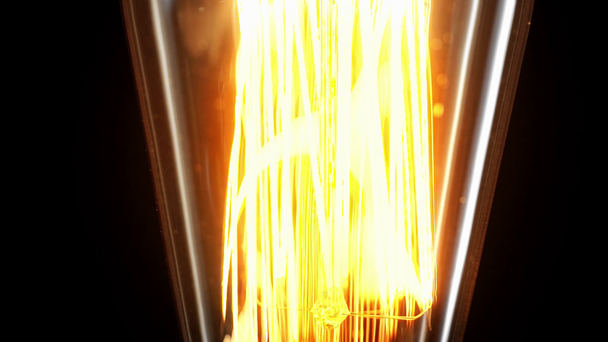 close up view of incandescent light bulb switching on isolated on black - Footage, Video