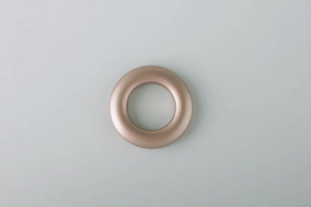 Curtain grommet ring for cornice fixing on grey background - Foto, afbeelding