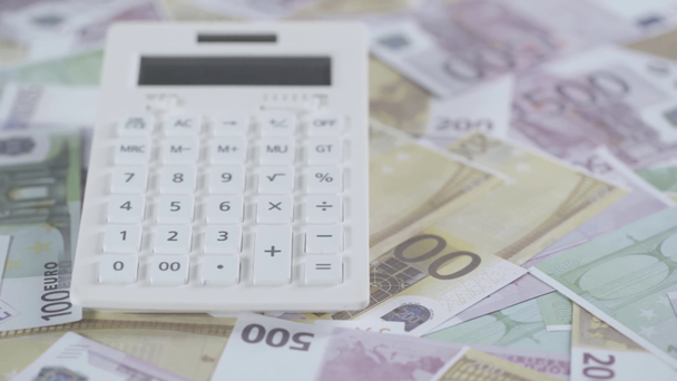 selective focus of scattered euro banknotes and calculator  - Filmati, video