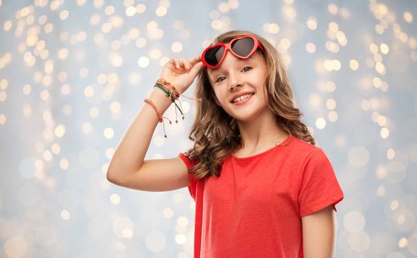 happy teenage girl in red heart shaped sunglasses - Photo, Image