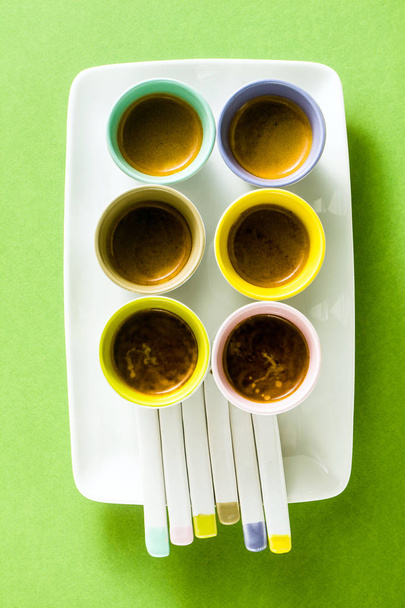 Six multicolored cups of Italian espresso coffee with porcelain  - Photo, Image