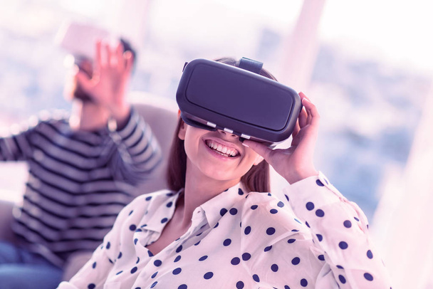 Positive delighted young female testing VR gadget - Foto, immagini