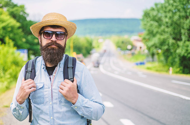 Looking for company. Look for fellow travelers. Tips of experienced tourist. Man bearded hipster tourist at edge of highway. Tourist waiting for car take him anyway just drop at better spot - Φωτογραφία, εικόνα